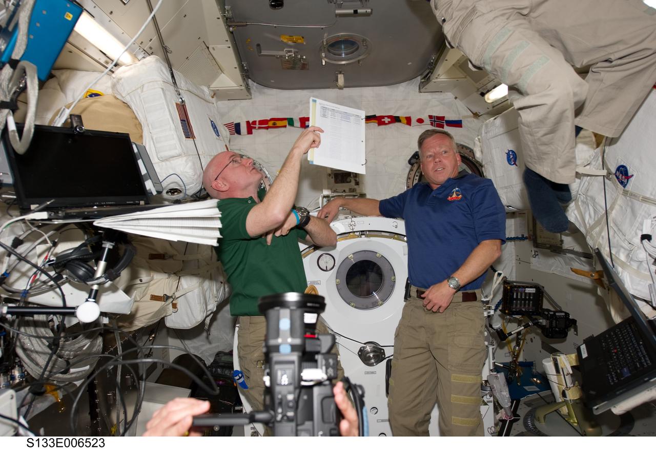 S133-E-006523 (26 Feb. 2011) --- NASA astronauts Scott Kelly (left), Expedition 26 commander; and Steve Lindsey, STS-133 commander, are pictured in the Kibo laboratory of the International Space Station while space shuttle Discovery remains docked with the station. Photo credit: NASA or National Aeronautics and Space Administration
