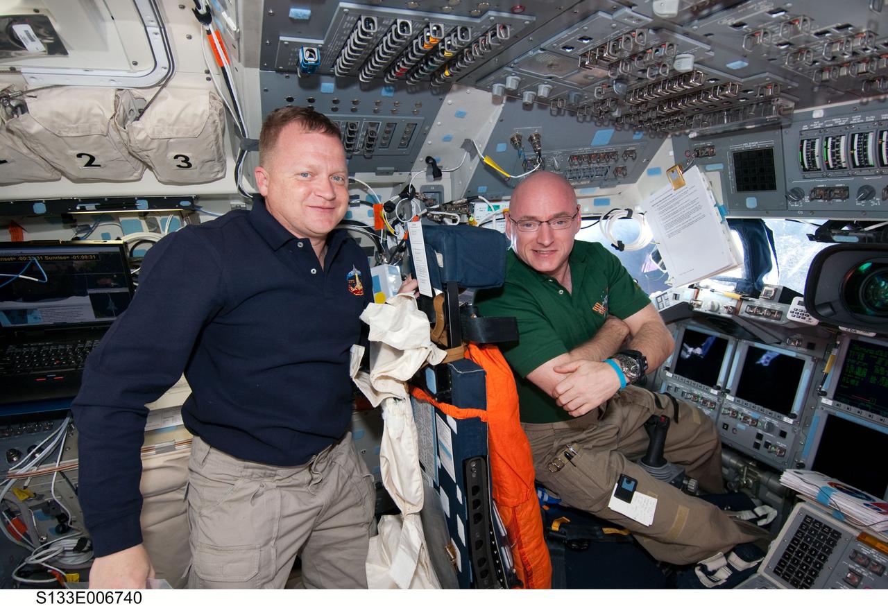 S133-E-006740 (26 Feb. 2011) --- NASA astronauts Eric Boe (left), STS-133 pilot; and Scott Kelly, Expedition 26 commander, take a moment for a photo on the flight deck of space shuttle Discovery while docked with the International Space Station. Photo credit: NASA or National Aeronautics and Space Administration