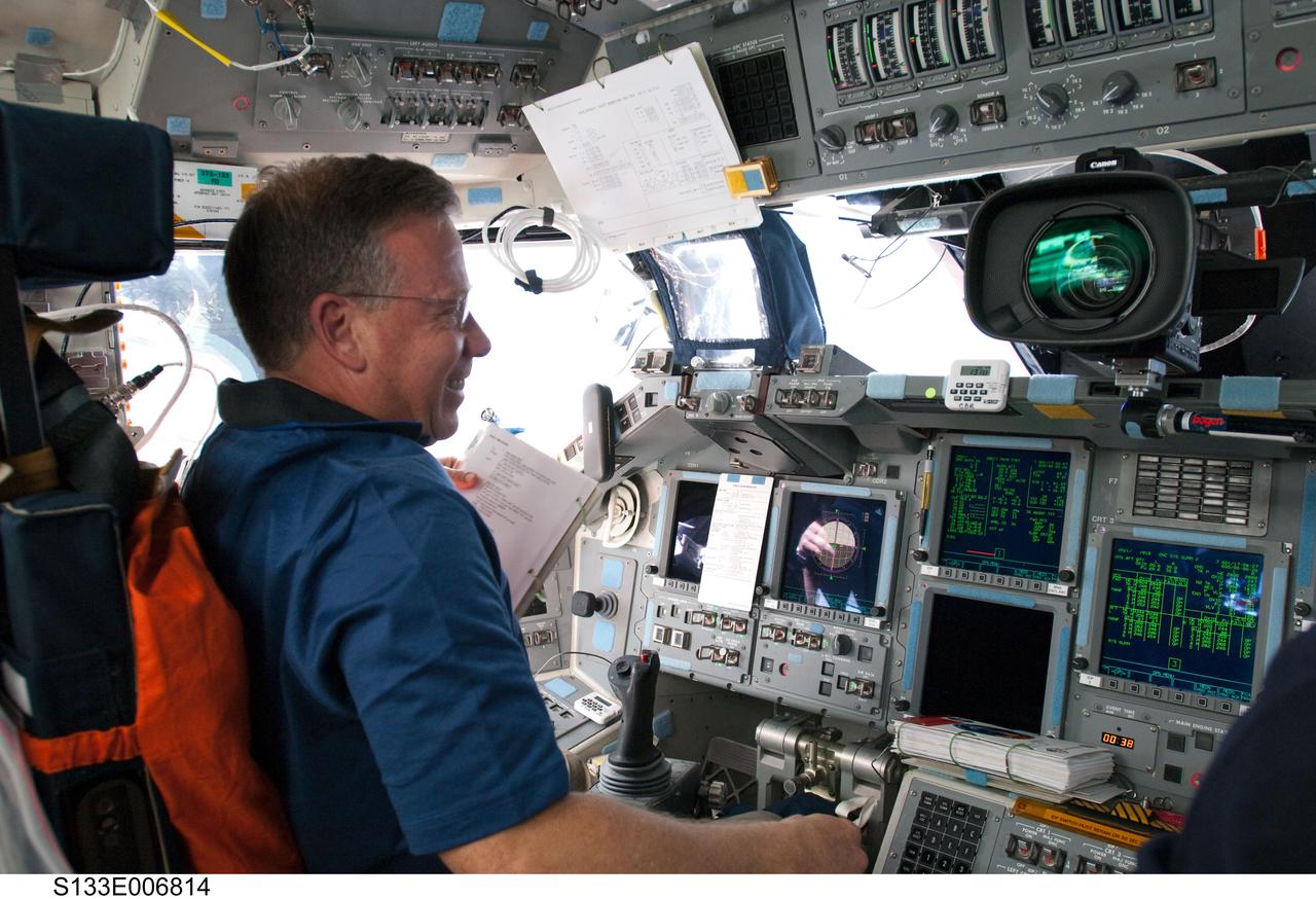 S133-E-006814 (26 Feb. 2011) --- NASA astronaut Steve Lindsey, STS-133 commander, occupies his station on the flight deck of space shuttle Discovery during flight day three activities. Photo credit: NASA or National Aeronautics and Space Administration