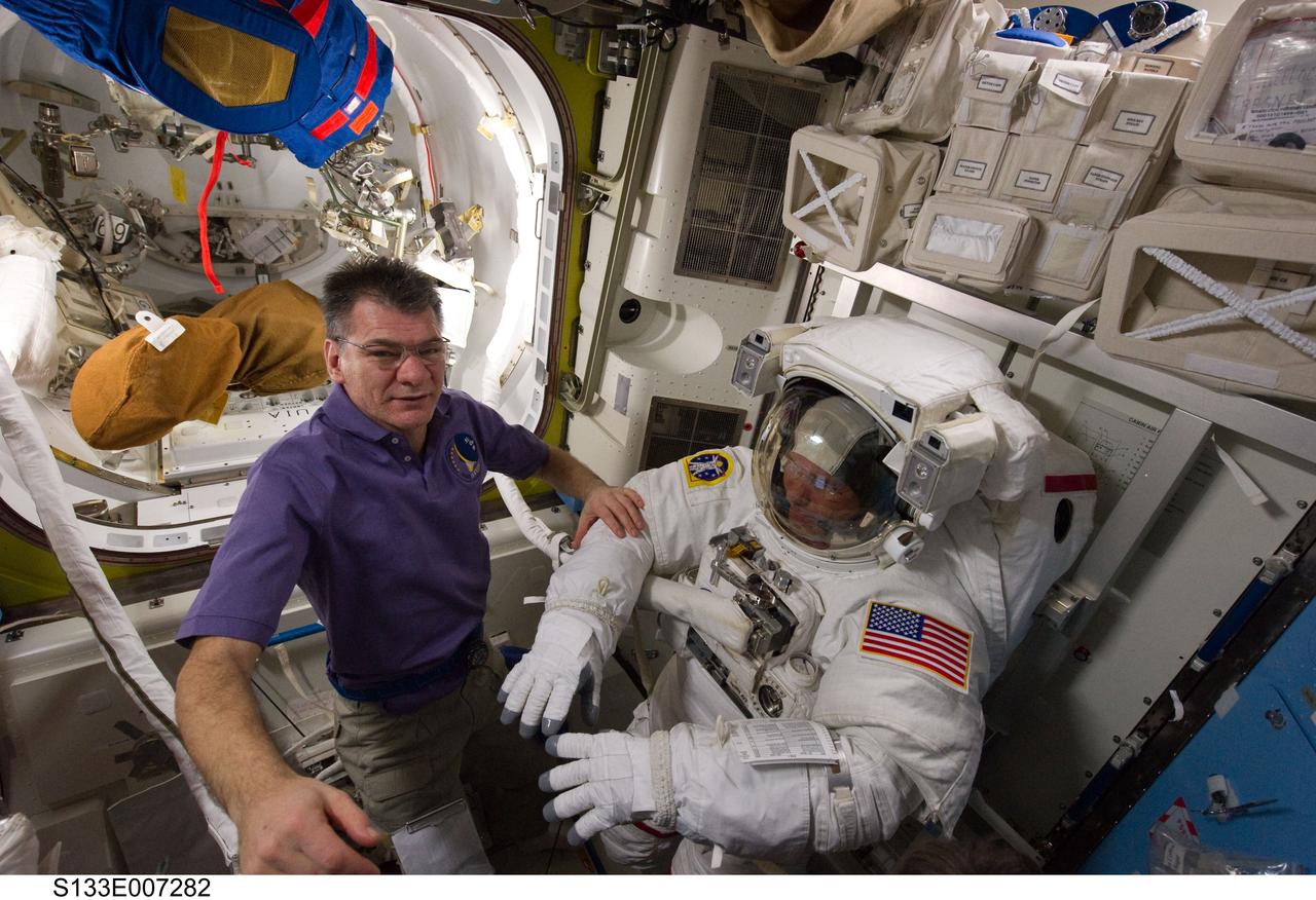 S133-E-007282 (28 Feb. 2011) --- European Space Agency astronaut Paolo Nespoli (left), Expedition 26 flight engineer; and NASA astronaut Steve Bowen, STS-133 mission specialist, are pictured in the Quest airlock of the International Space Station as they prepare for the start of the mission's first spacewalk. Bowen is wearing an Extravehicular Mobility Unit (EMU) spacesuit. Photo credit: NASA or National Aeronautics and Space Administration