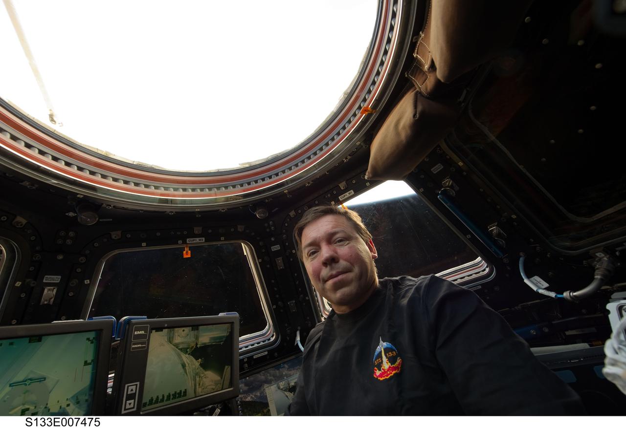 S133-E-007475 (1 March 2011) --- NASA astronaut Michael Barratt, STS-133 mission specialist, is pictured in the Cupola of the International Space Station while space shuttle Discovery remains docked with the station. Photo credit: NASA or National Aeronautics and Space Administration