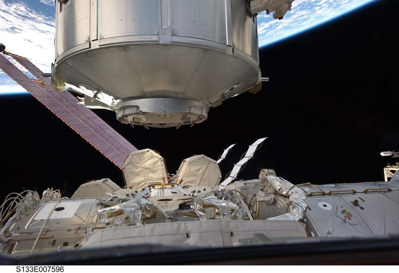 S133-E-007596 (1 March 2011) --- In the grasp of the International Space Station’s Canadarm2, the Italian-built Permanent Multipurpose Module (PMM) is transferred from space shuttle Discovery’s payload bay to be permanently attached to the Earth-facing port of the station’s Unity node. Earth’s horizon and the blackness of space provide the backdrop for the scene. Photo credit: NASA or National Aeronautics and Space Administration