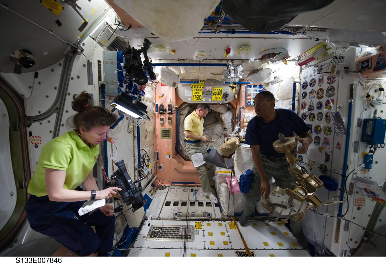 S133-E-007846 (1 March 2011) --- NASA astronaut Cady Coleman and European Space Agency astronaut Paolo Nespoli (background), both Expedition 26 flight engineers; along with NASA astronaut Alvin Drew, STS-133 mission specialist, work in the Unity node of the International Space Station while space shuttle Discovery remains docked with the station. Photo credit: NASA or National Aeronautics and Space Administration