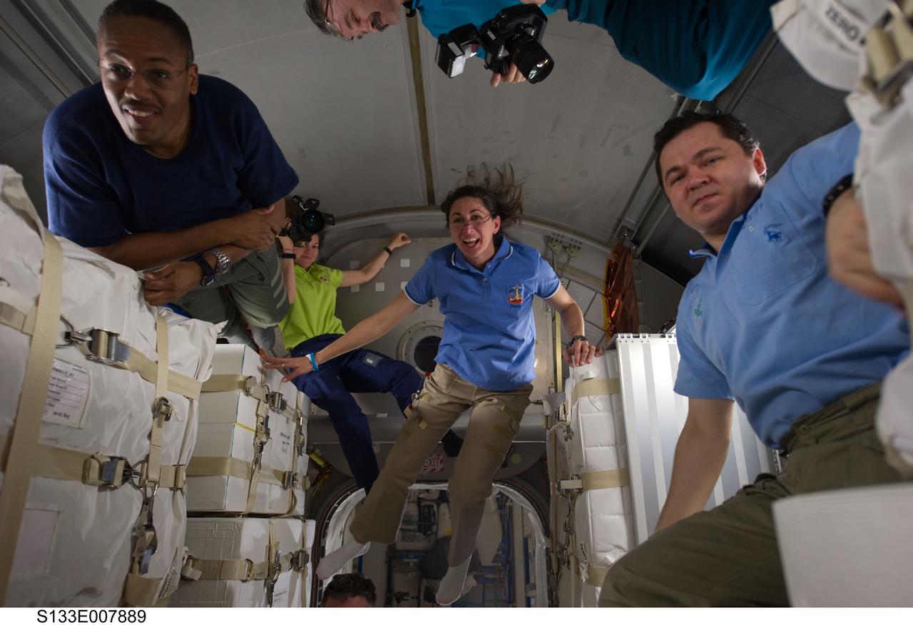 S133-E-007889 (1 March 2011) --- NASA astronauts Alvin Drew (left) and Nicole Stott (center), both STS-133 mission specialists; along with NASA astronaut Cady Coleman and Russian cosmonauts Oleg Skripochka and Alexander Kaleri (mostly out of frame at top), all Expedition 26 flight engineers, are pictured in the newly-installed Permanent Multipurpose Module (PMM) of the International Space Station while space shuttle Discovery remains docked with the station. Photo credit: NASA or National Aeronautics and Space Administration