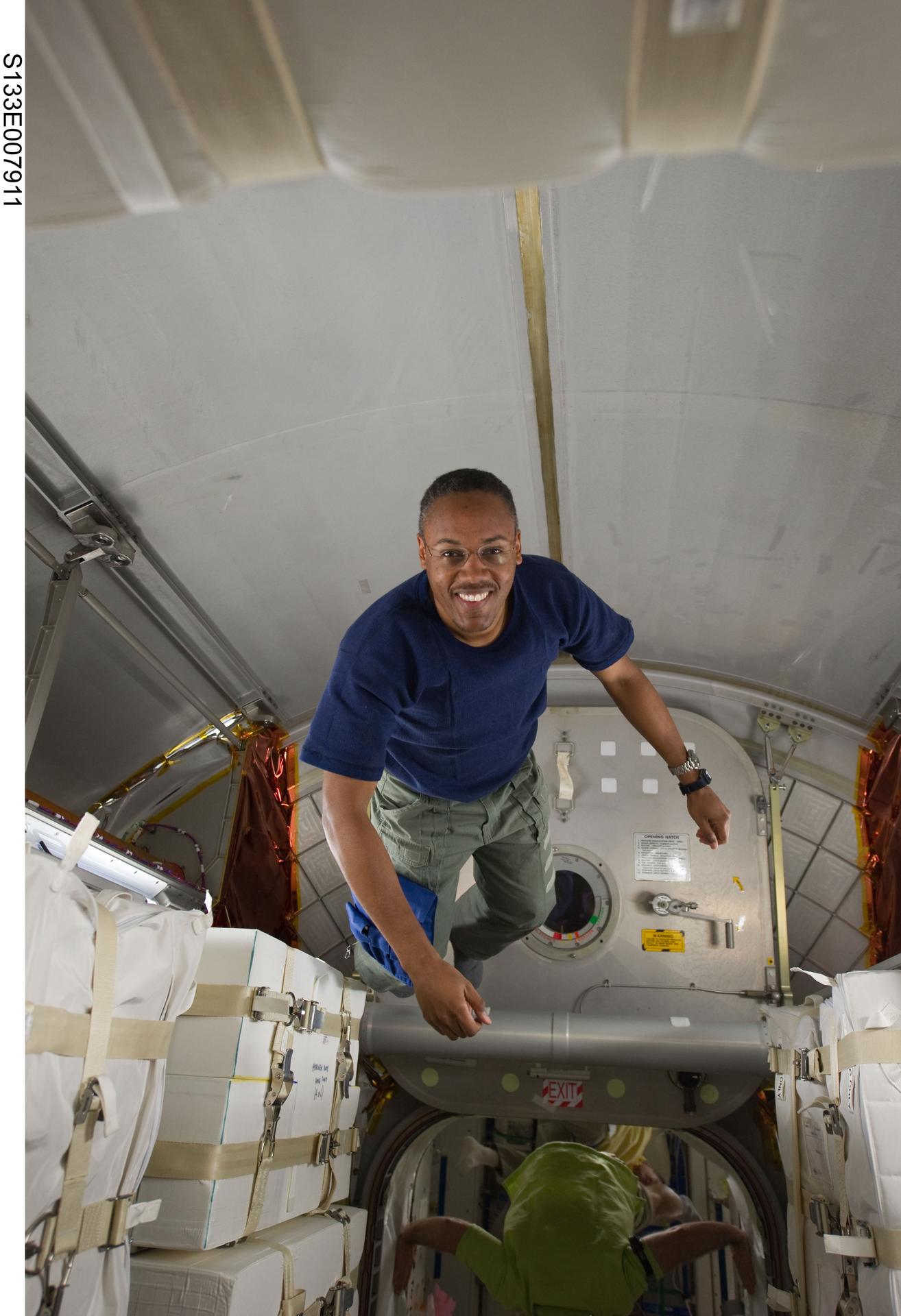 Astronaut Alvin Drew floats in the Permanent Multipurpose Module in March 2011