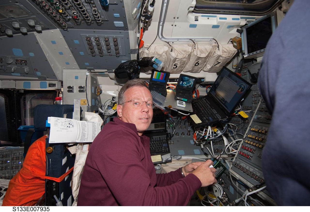 S133-E-007935 (28 Feb. 2011) --- NASA astronaut Steve Lindsey, STS-133 commander, works on the aft flight deck of space shuttle Discovery while docked with the International Space Station. Photo credit: NASA or National Aeronautics and Space Administration