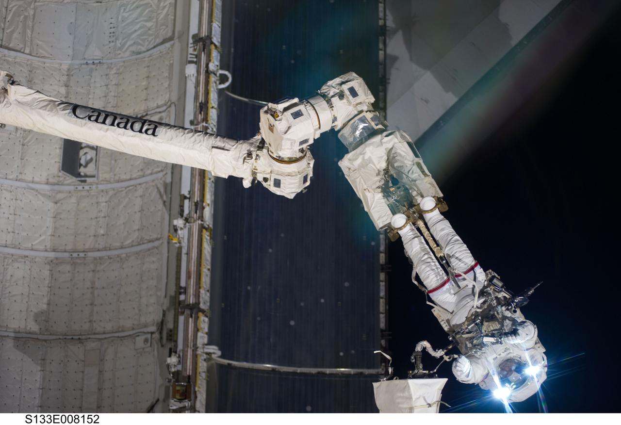 S133-E-008152 (2 March 2011) --- Anchored to a Canadarm2 mobile foot restraint, NASA astronaut Steve Bowen, STS-133 mission specialist, participates in the mission’s second session of extravehicular activity (EVA) as construction and maintenance continue on the International Space Station. During the six-hour, 14-minute spacewalk, Bowen and astronaut Alvin Drew (out of frame), mission specialist, tackled a variety of tasks, including venting into space some remaining ammonia from a failed pump module they moved during the mission’s first spacewalk. Photo credit: NASA or National Aeronautics and Space Administration