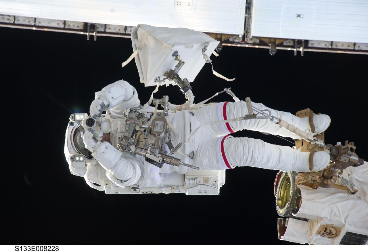 S133-E-008228 (2 March 2011) --- Anchored to a Canadarm2 mobile foot restraint, NASA astronaut Steve Bowen, STS-133 mission specialist, participates in the mission’s second session of extravehicular activity (EVA) as construction and maintenance continue on the International Space Station. During the six-hour, 14-minute spacewalk, Bowen and astronaut Alvin Drew (out of frame), mission specialist, tackled a variety of tasks, including venting into space some remaining ammonia from a failed pump module they moved during the mission’s first spacewalk. Photo credit: NASA or National Aeronautics and Space Administration
