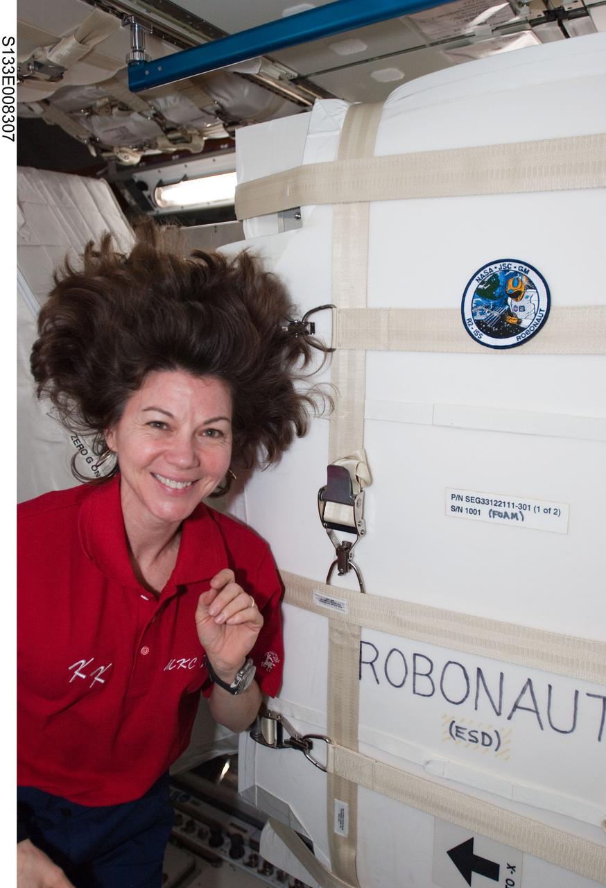 S133-E-008307 (2 March 2011) --- NASA astronaut Cady Coleman, Expedition 26 flight engineer, is pictured near the Robonaut2 container in the newly-installed Permanent Multipurpose Module (PMM) of the International Space Station while space shuttle Discovery (STS-133) remains docked with the station. Photo credit: NASA or National Aeronautics and Space Administration