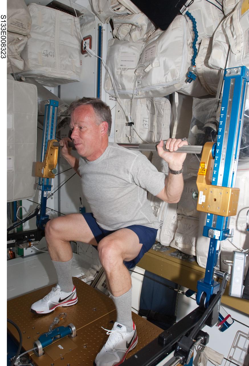 S133-E-008323 (3 March 2011) --- NASA astronaut Steve Lindsey, STS-133 commander, exercises using the advanced Resistive Exercise Device (aRED) in the Tranquility node of the International Space Station while space shuttle Discovery remains docked with the station. Photo credit: NASA or National Aeronautics and Space Administration