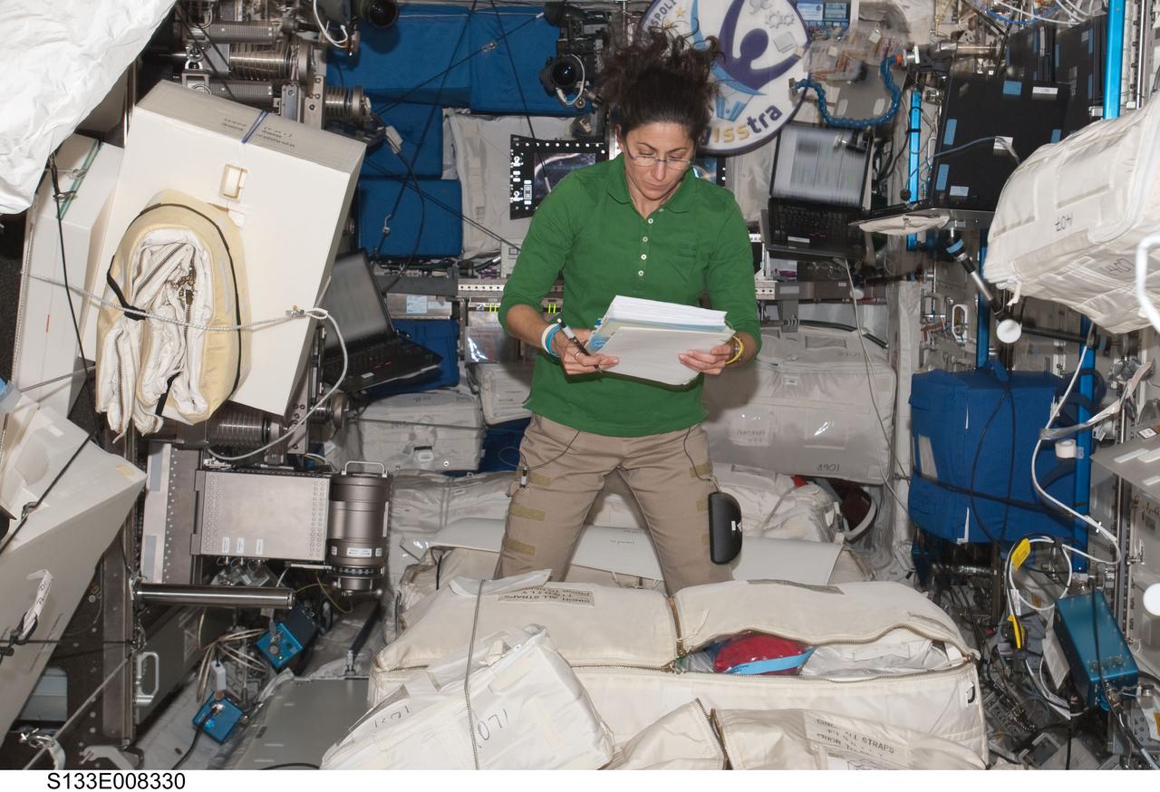 S133-E-008330 (3 March 2011) --- NASA astronaut Nicole Stott, STS-133 mission specialist, reads a checklist in the Columbus laboratory of the International Space Station while space shuttle Discovery remains docked with the station. Photo credit: NASA or National Aeronautics and Space Administration