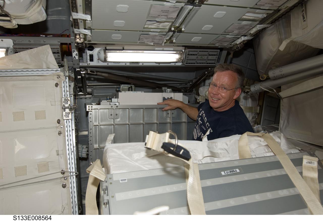 S133-E-008564 (4 March 2011) --- It's another moving day onboard the International Space Station, as NASA astronaut Steve Lindsey, STS-133 commander, participates in the team effort of 12 total astronauts and cosmonauts working together temporarily onboard the orbital outpost. The joint crews added the Permanent Multipurpose Module (PMM) to the station earlier in the week. Photo credit: NASA or National Aeronautics and Space Administration