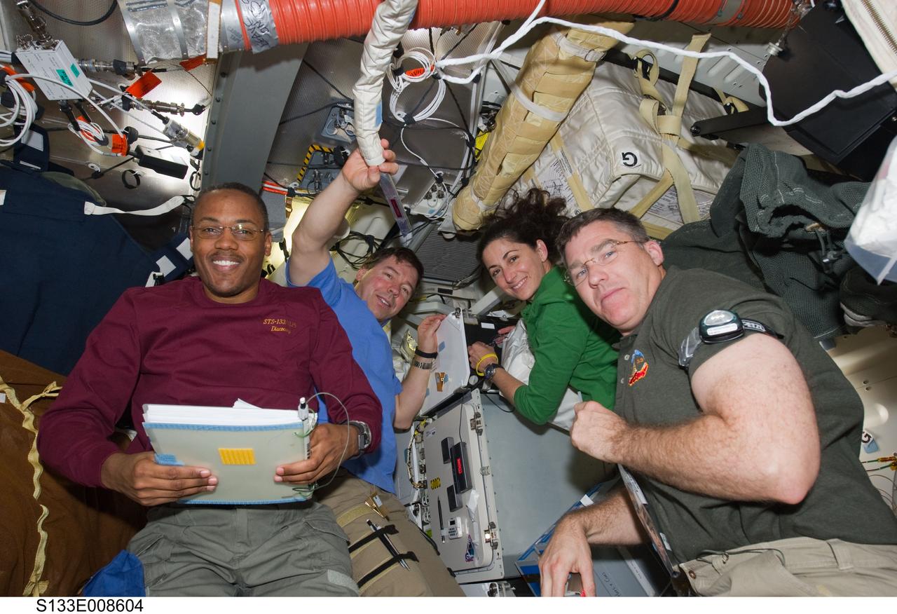 STS-133 and Expedition 26 crew on middeck