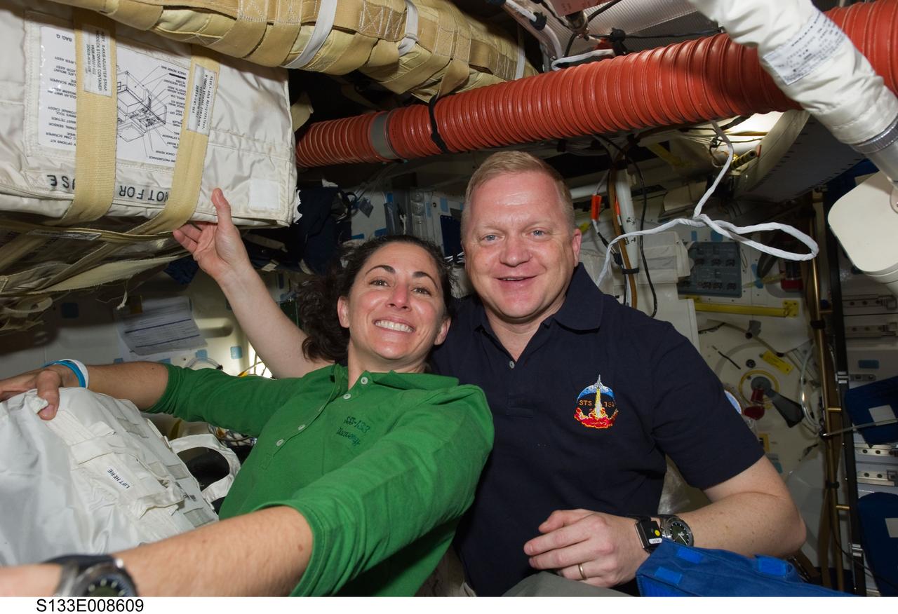 S133-E-008609 (3 March 2011) --- On Discovery's middeck, while the shuttle was docked to the International Space Station, NASA astronauts Nicole Stott, STS-133 mission specialist, and Eric Boe, pilot, appear joyous at the progress of a series of moving days onboard the tandem of orbital spacecraft.  Photo credit:  NASA or National Aeronautics and Space Administration.
