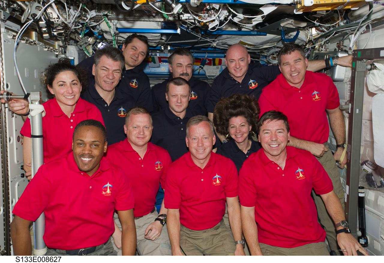 S133-E-008627 (3 March 2011) --- Inside the U.S. lab Destiny, 12 astronauts and cosmonauts take a break from a very busy week aboard the International Space Station to pose for a joint STS-133/Expedition 26 group portrait. The STS-133 crew members, all attired in red shirts (from left) are NASA astronauts Nicole Stott, Alvin Drew, Eric Boe, Steve Lindsey, Michael Barratt and Steve Bowen. The dark blue-attired Expedition 26 crew members, from left, are European Space Agency astronaut Paolo Nespoli, along with Russian cosmonauts Oleg Skripochka, Dmitry Kondratyev (below), and Alexander Kaleri and astronauts Scott Kelly and Cady Coleman (below). Serving the STS-133 and Expedition 26 missions as commanders were Lindsey and Kelly, respectively. Photo credit: NASA or National Aeronautics and Space Administration