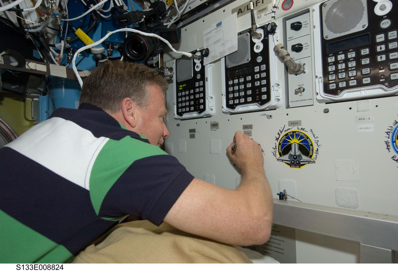 S133-E-008824 (5 March 2011) --- NASA astronaut Steve Lindsey, STS-133 commander, signs the STS-133 patch, which was added to the growing collection of insignias representing crews who performed spacewalks from the Quest airlock of the International Space Station. Photo credit: NASA or National Aeronautics and Space Administration