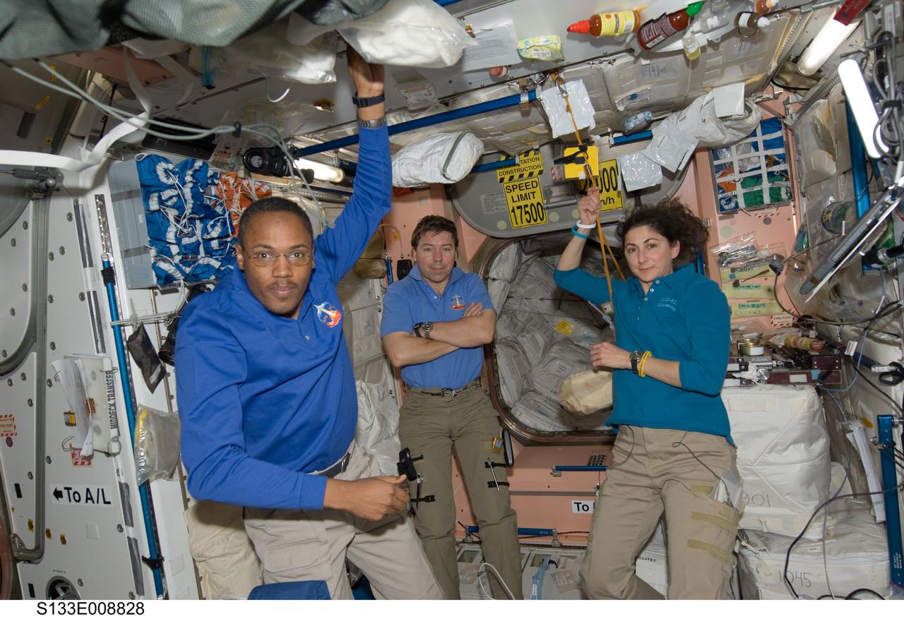 S133-E-008828 (5 March 2011) --- NASA astronauts Alvin Drew (left), Michael Barratt and Nicole Stott, all STS-133 mission specialists, are pictured in the Unity node of the International Space Station while space shuttle Discovery remains docked with the station. Photo credit: NASA or National Aeronautics and Space Administration