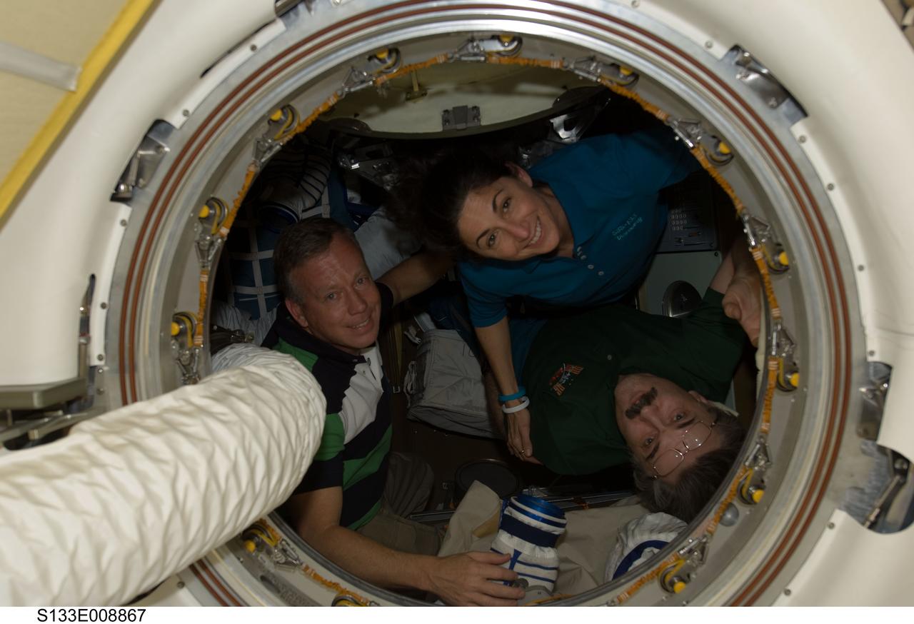S133-E-008867 (5 March 2011) --- NASA astronauts Steve Lindsey (left), STS-133 commander, and Nicole Stott, mission specialist; along with Russian cosmonaut Alexander Kaleri, Expedition 26 flight engineer, are pictured in a Russian Soyuz spacecraft, docked to the International Space Station, while space shuttle Discovery remains linked with the station. Photo credit: NASA or National Aeronautics and Space Administration