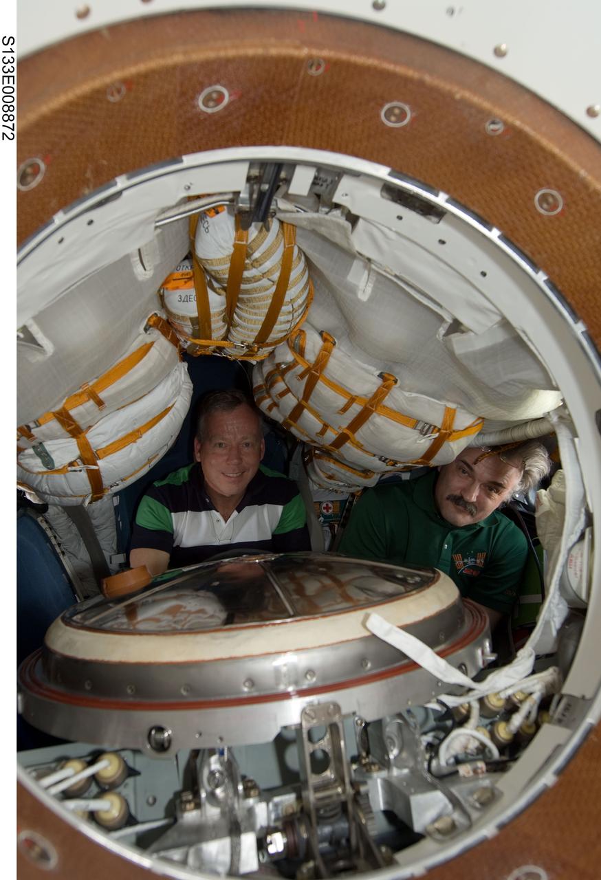 S133-E-008872 (5 March 2011) --- NASA astronaut Steve Lindsey (left), STS-133 commander; and Russian cosmonaut Alexander Kaleri, Expedition 26 flight engineer, are pictured in a Russian Soyuz spacecraft, docked to the International Space Station, while space shuttle Discovery remains linked with the station. Photo credit: NASA or National Aeronautics and Space Administration