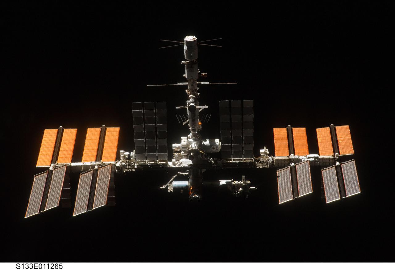 S133-E-011265 (7 March 2011) ---  Backdropped against the blackness of space, the International Space Station is seen from   Discovery as the two orbital spacecraft accomplish their relative separation on March 7 after an aggregate of 12 astronauts and cosmonauts worked together for over a week.   During a post undocking fly-around, the crew members aboard the two spacecraft collected a series of photos of each other?s vehicle.  Photo credit: NASA or National Aeronautics and Space Administration