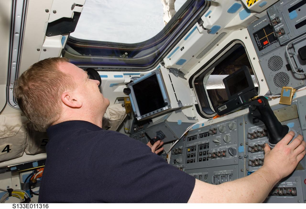S133-E-011316 (7 March 2011) --- NASA astronaut Eric Boe, STS-133 pilot, is pictured on the aft flight deck of space shuttle Discovery during flight day 12 activities. Photo credit: NASA or National Aeronautics and Space Administration