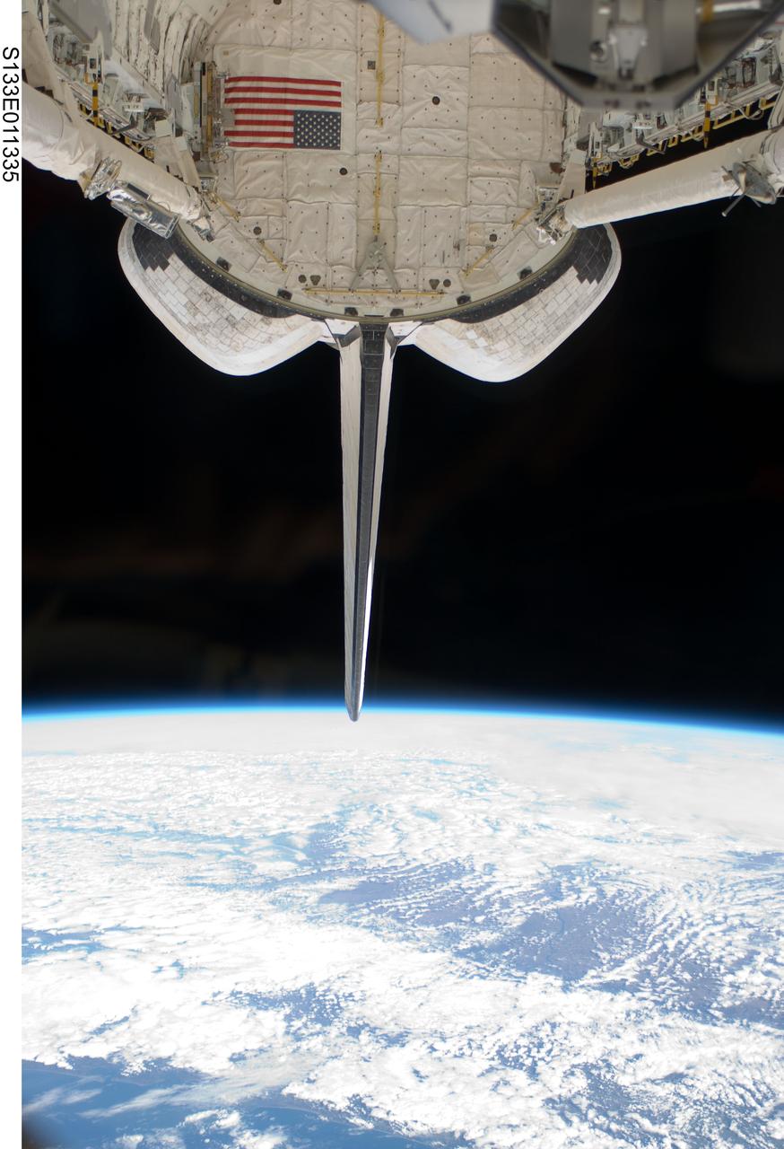 S133-E-011335 (7 March 2011) --- Space shuttle Discovery’s vertical stabilizer, orbital maneuvering system (OMS) pods, remote manipulator system/orbiter boom sensor system (RMS/OBSS) and payload bay are featured in this image photographed by an STS-133 crew member on the shuttle during flight day 12 activities. Earth's horizon and the blackness of space provide the backdrop for the scene. Photo credit: NASA or National Aeronautics and Space Administration