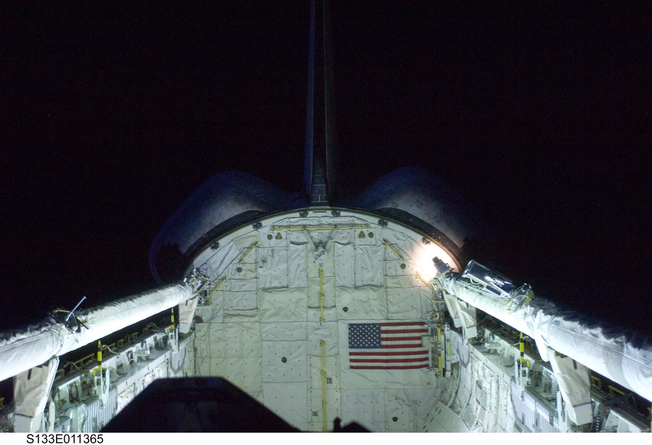 S133-E-011365 (7 March 2011) --- Space shuttle Discovery’s vertical stabilizer, orbital maneuvering system (OMS) pods, remote manipulator system/orbiter boom sensor system (RMS/OBSS) and payload bay are featured in this image photographed by an STS-133 crew member on the shuttle during flight day 12 activities. Photo credit: NASA or National Aeronautics and Space Administration