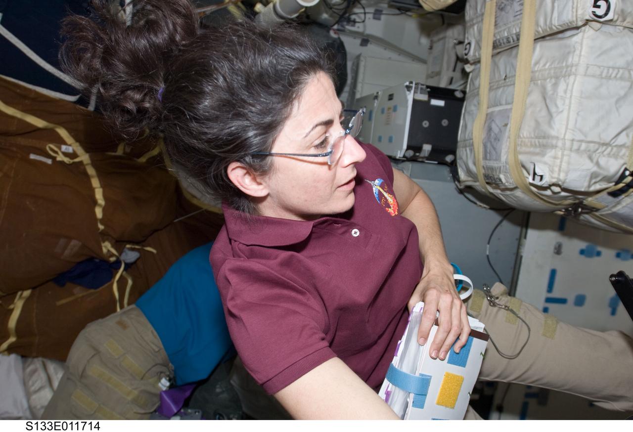 S133-E-011714 (7 March 2011) --- NASA astronaut Nicole Stott, STS-133 mission specialist, works on the middeck of space shuttle Discovery during flight day 12 activities. Photo credit: NASA or National Aeronautics and Space Administration