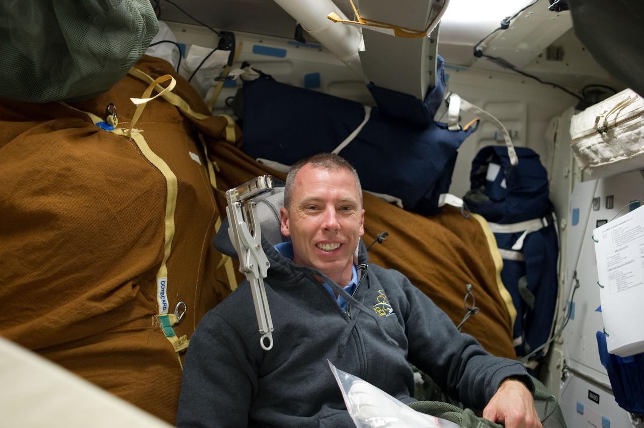 S134-E-006392 (17 May 2011) -- During the second flight day of Endeavour's final mission, astronaut Andrew Feustel, STS-134 mission specialist, realizes he likely won't recognize this area of the spacecraft's middeck at mission's end in 16-days, when all the supplies and equipment will have been moved to other locations on the shuttle and on the International Space Station. Feustel and his five crewmates are settling in for almost two weeks of work on the orbital outpost. Photo credit: NASA