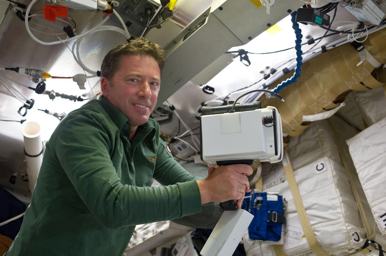 S134-E-006397 (17 May 2011) --- On Endeavour's middeck, European Space Agency astronaut Roberto Vittori, STS-134 mission specialist, unpacks the laser range finder, which will come in handy in 24 hours on the shuttle's flight deck when the spacecraft and the International Space Station approach each other for docking. Photo credit: NASA