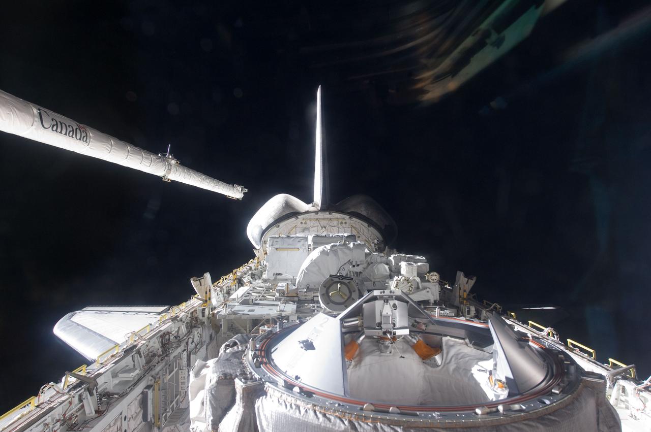 S134-E-006505 (17 May 2011) --- The Orbiter Boom Sensor System (OBSS), pictured on the second flight day of STS-134, on left side of this photo showing Endeavour's vertical stabilizer and cargo bay, is a 50-foot boom carried onboard each of NASA's space shuttles. The boom can be grappled by the Canadarm and serves as an extension of the arm, doubling its length to a combined total of 100 feet (30 meters). At the far end of the boom is an instrumentation package of cameras and lasers used to scan the leading edges of the wings, the nose cap, and the crew compartment after each lift-off and before each landing. Photo credit: NASA