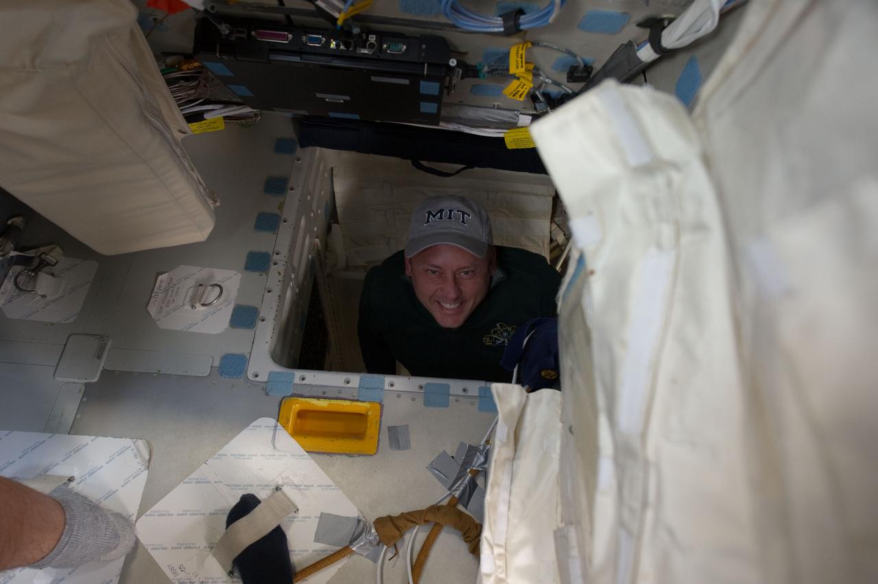 S134-E-006531 (17 May 2011) --- Onboard space shuttle Endeavour, astronaut Michael Fincke, STS-134 mission specialist, merely needs to shove off one of his legs and leap and he transports his body from middeck to flight deck. In Earth-bound trainers, such a move required a  stationary ladder. A former long-duration occupant of the International Space Station (ISS), Fincke joins five other veteran astronauts for this final mission of Endeavour -- a 16-day affair that will allow the crew to spend almost two full weeks onboard the orbiting ISS/shuttle joint complex. Docking day is a day away from the time this image was recorded. Photo credit: NASA