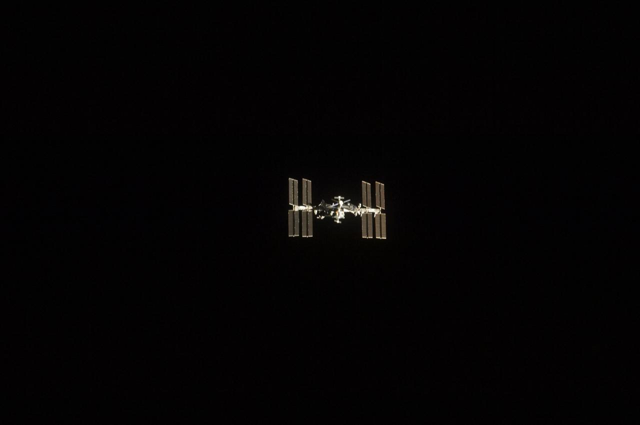 S134-E-006596 (18 May 2011) --- One of the STS-134 crew members aboard the space shuttle Endeavour recorded this image of the International Space Station (ISS), backdropped against the blackness of space, as the two spacecraft made their relative approach on May 18, 2011. Each spacecraft was occupied by six crew members until the STS-134 astronauts entered the ISS a short while after the docking. Photo credit: NASA