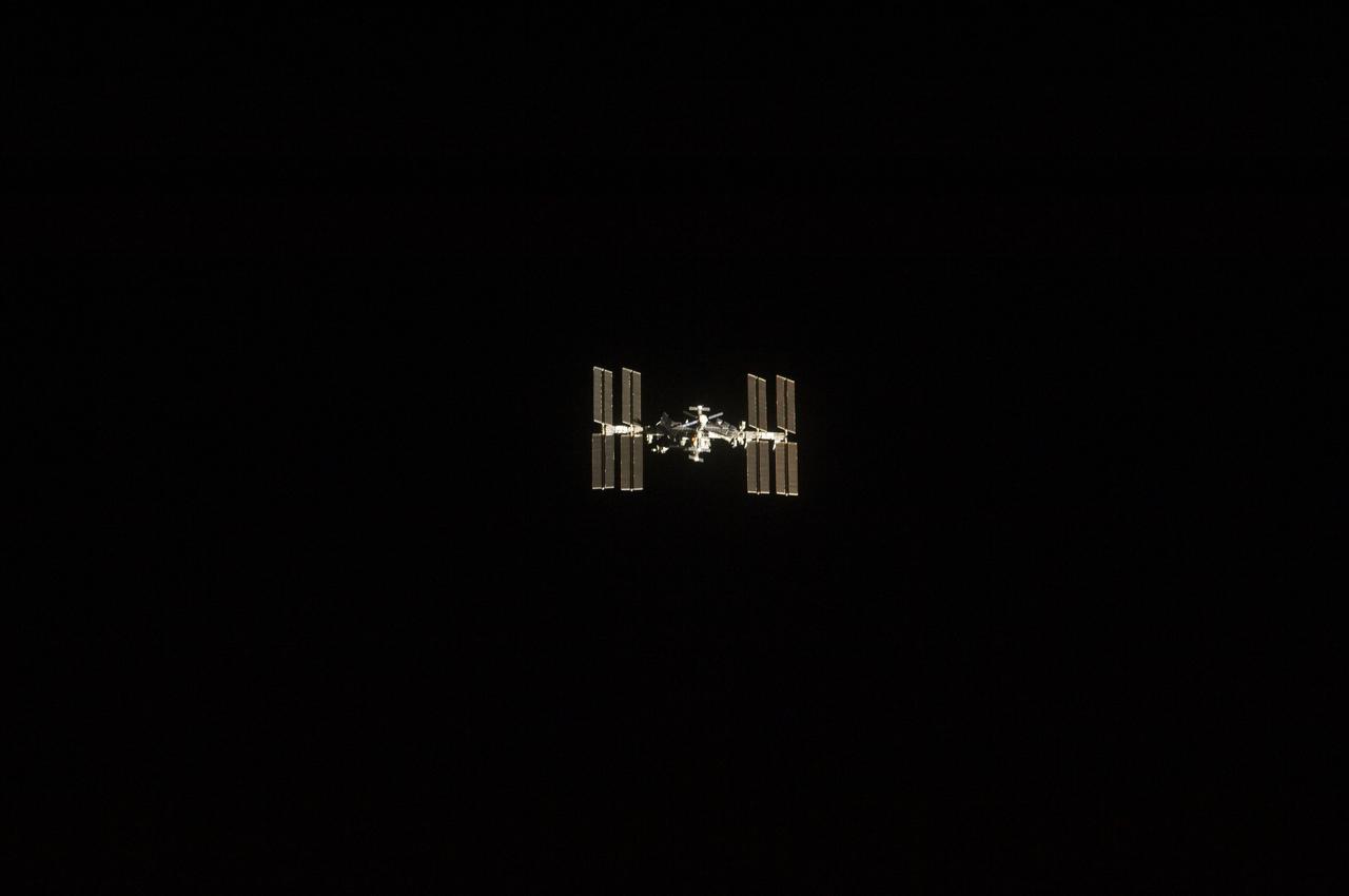 S134-E-006597 (18 May 2011) --- One of the STS-134 crew members aboard the space shuttle Endeavour recorded this image of the International Space Station (ISS), backdropped against the blackness of space, as the two spacecraft made their relative approach on May 18, 2011. Each spacecraft was occupied by six crew members until the STS-134 astronauts entered the ISS a short while after the docking. Photo credit: NASA