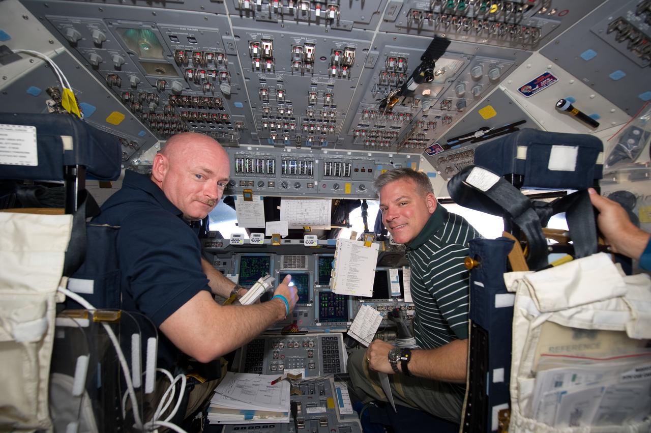 S134-E-006857 (18 May 2011) --- NASA astronauts Mark Kelly (left), STS-134 commander; and Greg H. Johnson, pilot, occupy their respective stations on the forward flight deck of space shuttle Endeavour during rendezvous and docking operations with the International Space Station on flight day three. Photo credit: NASA