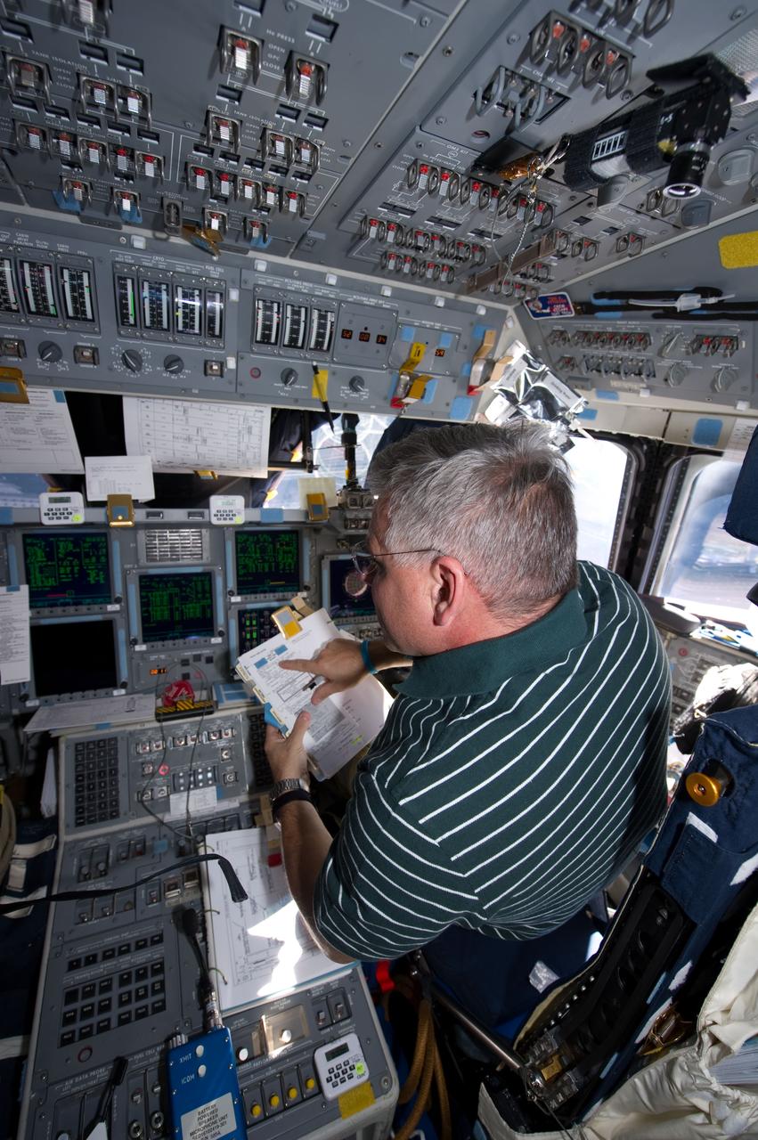 S134-E-006882 (18 May 2011) --- NASA astronaut Greg H. Johnson, STS-134 pilot, occupies his station on the forward flight deck of space shuttle Endeavour during rendezvous and docking operations with the International Space Station on flight day three. Photo credit: NASA