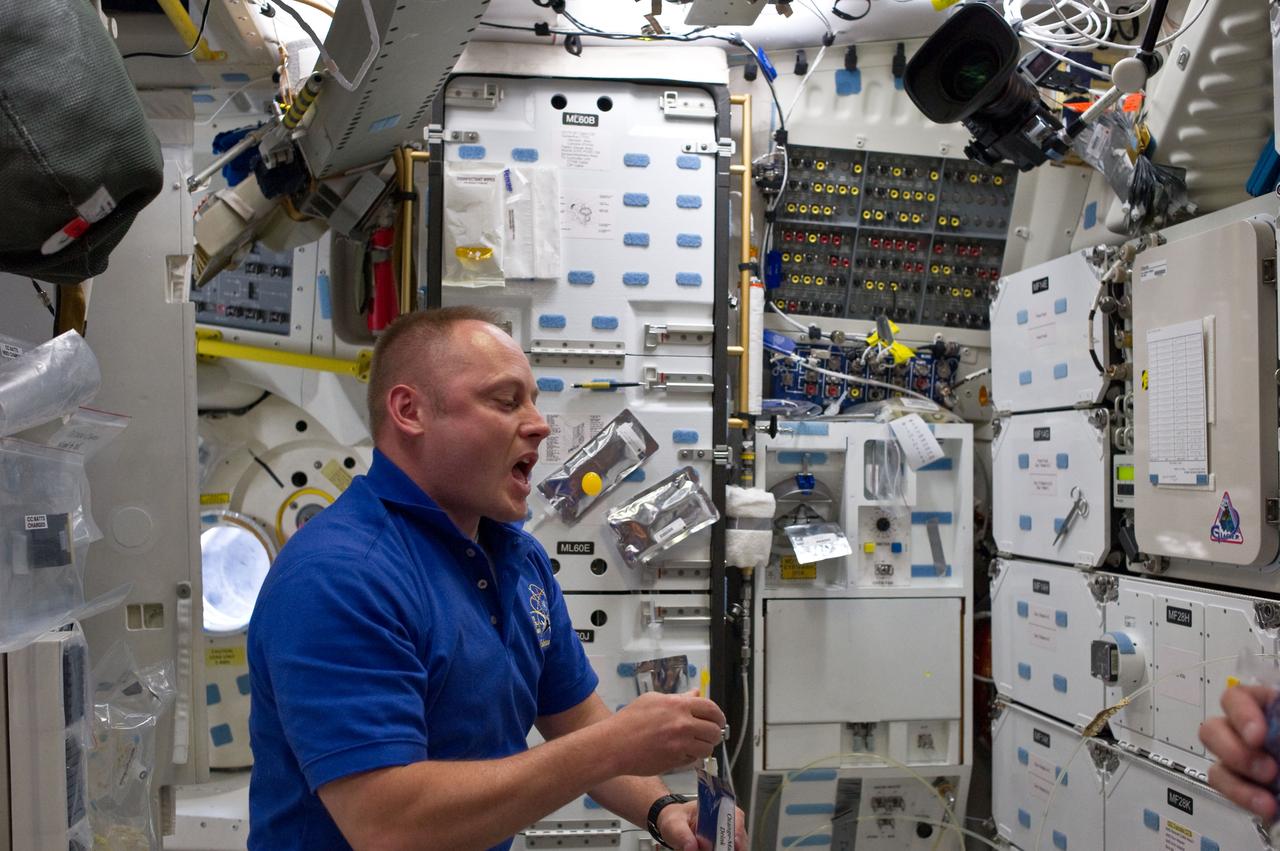 S134-E-007020 (18 May 2011) --- NASA astronaut Michael Fincke, STS-134 mission specialist, attempts to catch a bubble squeezed from his beverage container on the middeck of space shuttle Endeavour during flight day three activities. Photo credit: NASA