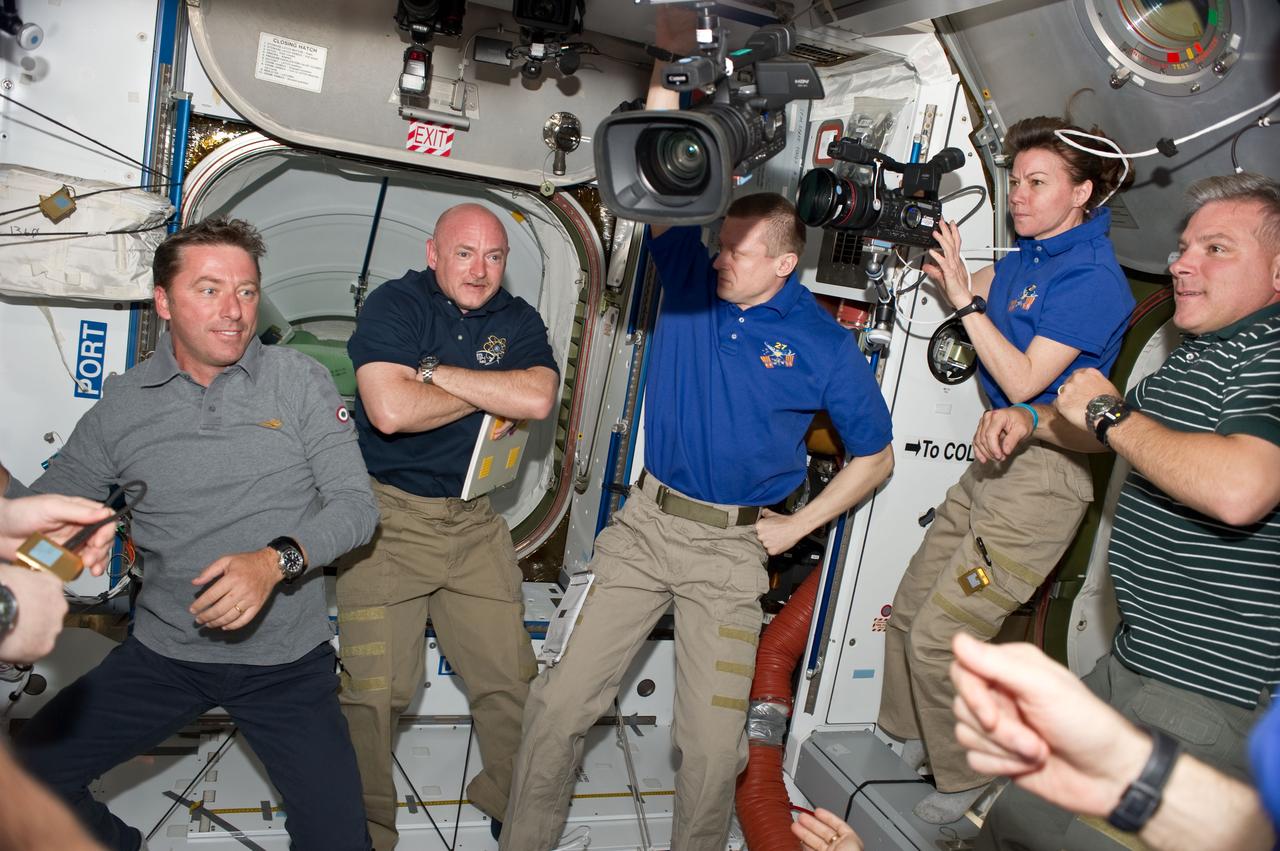 S134-E-007107 (18 May 2011) --- STS-134 and Expedition 27 crew members are pictured in the Harmony node of the International Space Station shortly after space shuttle Endeavour and the space station docked in space and the hatches were opened. Pictured from the left are European Space Agency astronaut Roberto Vittori, STS-134 mission specialist; NASA astronaut Mark Kelly, STS-134 commander; Russian cosmonaut Dmitry Kondratyev, Expedition 27 commander; NASA astronaut Cady Coleman, Expedition 27 flight engineer; and NASA astronaut Greg H. Johnson, STS-134 pilot. Photo credit: NASA