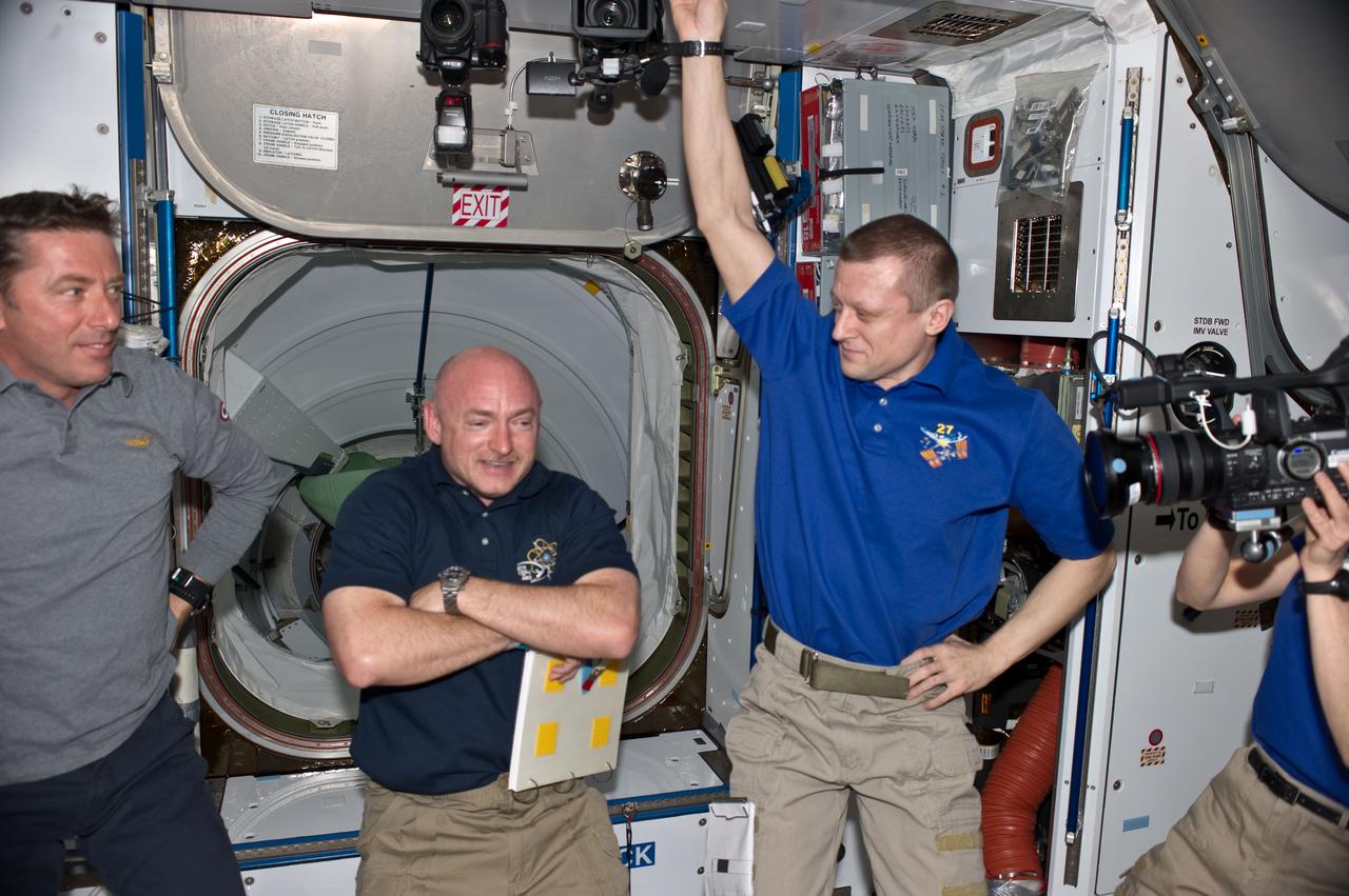S134-E-007114 (18 May 2011) --- STS-134 and Expedition 27 crew members are pictured in the Harmony node of the International Space Station shortly after space shuttle Endeavour and the space station docked in space and the hatches were opened. Pictured from the left are European Space Agency astronaut Roberto Vittori, STS-134 mission specialist; NASA astronaut Mark Kelly, STS-134 commander; and Russian cosmonaut Dmitry Kondratyev, Expedition 27 commander. Photo credit: NASA