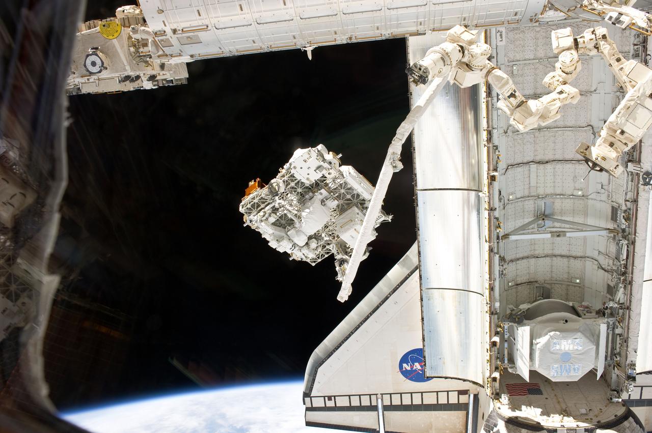 S134-E-007141 (18 May 2011) --- In the grasp of space shuttle Endeavour?s robotic Canadarm, the Express Logistics Carrier-3 (ELC-3) is transferred from Endeavour?s payload bay for hand off to the International Space Station?s Canadarm2 to be installed on the left side of the station?s truss structure. ELC-3 holds spare hardware for future station use, including an ammonia tank, a high pressure gas tank, a cargo transport container, two S-band antenna assemblies and a spare arm for DEXTRE, the Special Purpose Dexterous Manipulator. Photo credit: NASA