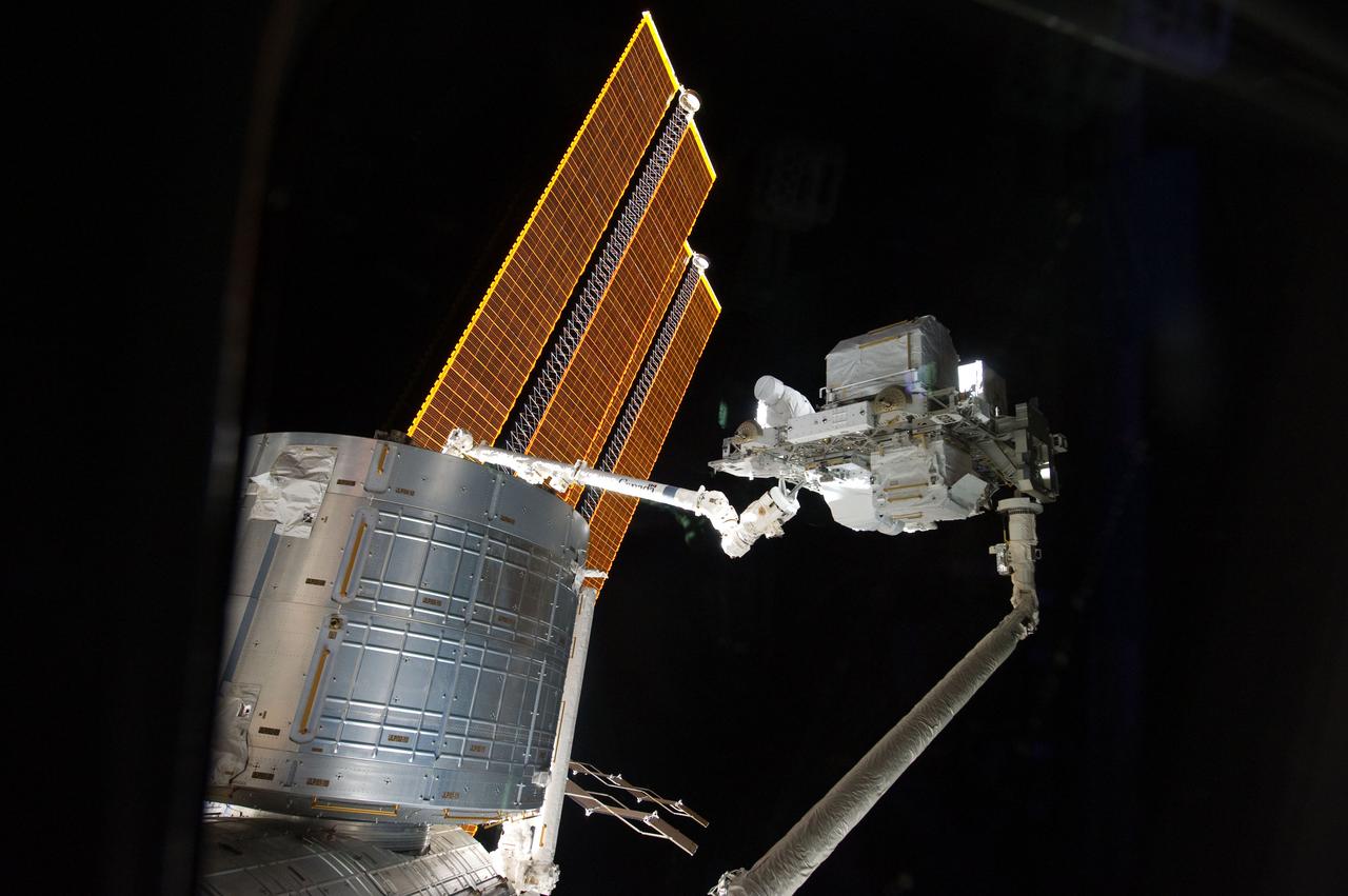 S134-E-007327 (18 May 2011) --- The handoff between space shuttle Endeavour?s robotic Canadarm and the International Space Station?s Canadarm2 of the Express Logistics Carrier-3 (ELC-3) is featured in this image photographed by an STS-134 crew member on the station. The ELC-3 was later installed on the left side of the station?s truss structure. ELC-3 holds spare hardware for future station use, including an ammonia tank, a high pressure gas tank, a cargo transport container, two S-band antenna assemblies and a spare arm for DEXTRE, the Special Purpose Dexterous Manipulator. Photo credit: NASA