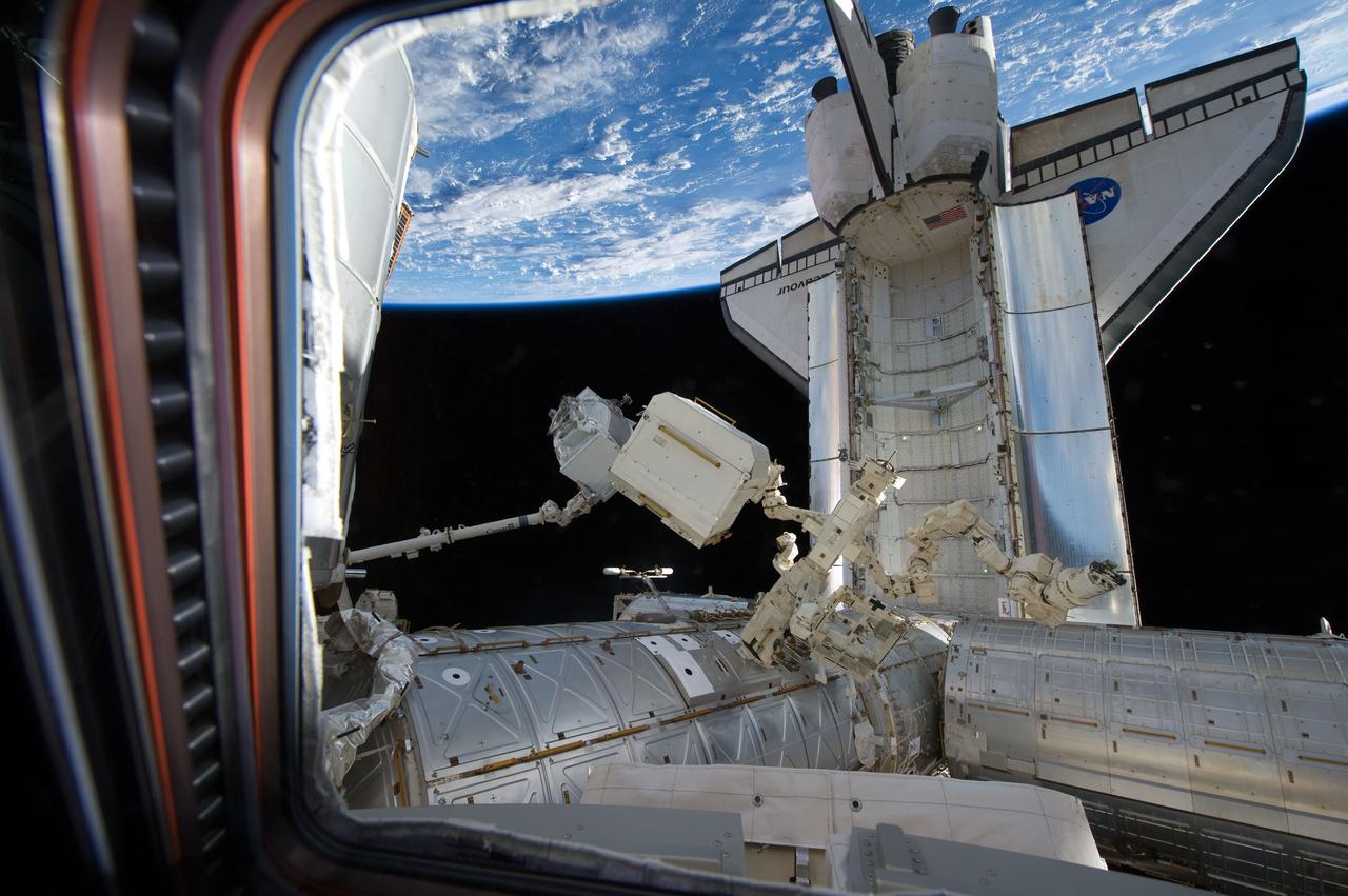 S134-E-007444 (19 May 2011) --- In the grasp of the International Space Station?s Canadarm2, the Alpha Magnetic Spectrometer-2 (AMS) is transferred from space shuttle Endeavour?s payload bay for installation on the station?s starboard truss. Photo credit: NASA