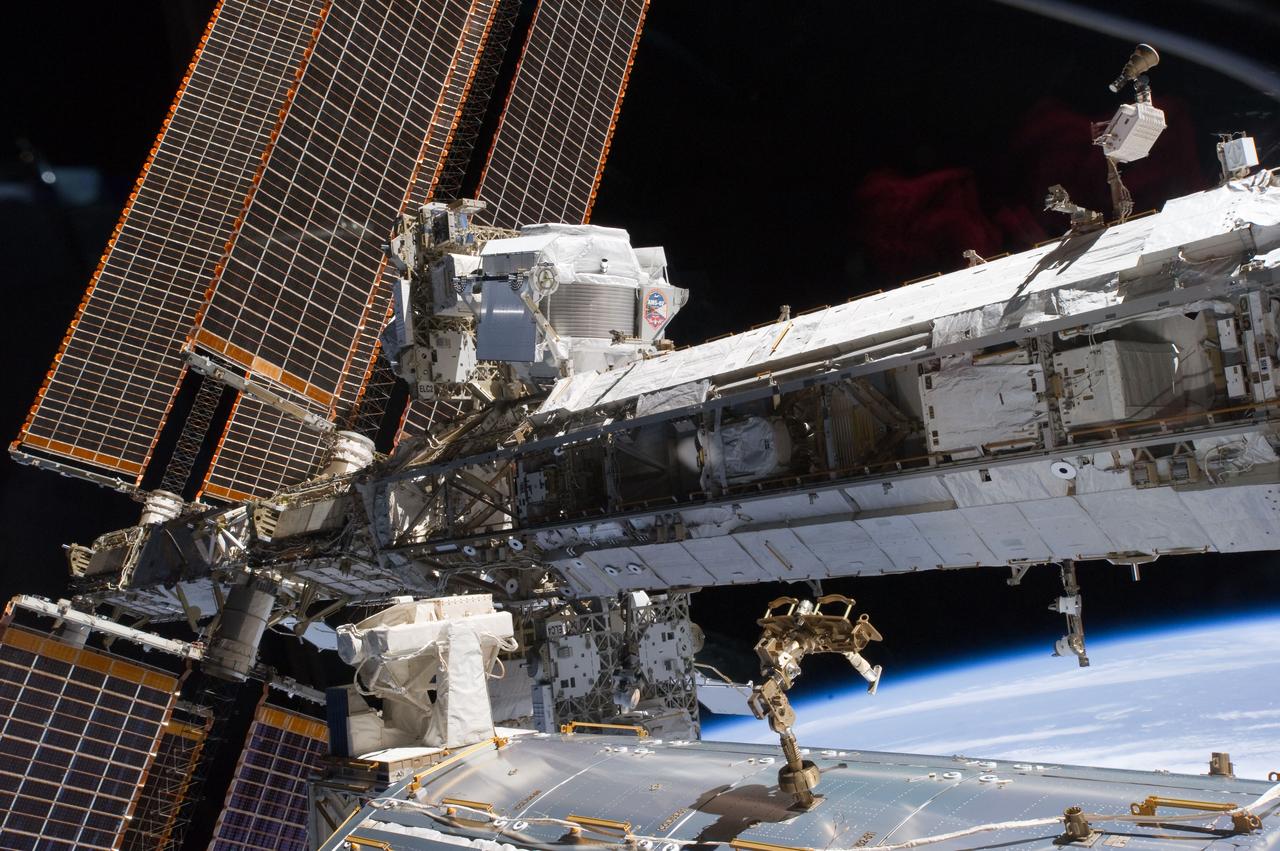 S134-E-007532 (20 May 2011) --- The starboard truss of the International Space Station is featured in this image photographed by an STS-134 crew member while space shuttle Endeavour remains docked with the station. The newly-installed Alpha Magnetic Spectrometer-2 (AMS) is visible at center left. The blackness of space and Earth?s horizon provide the backdrop for the scene. Photo credit: NASA