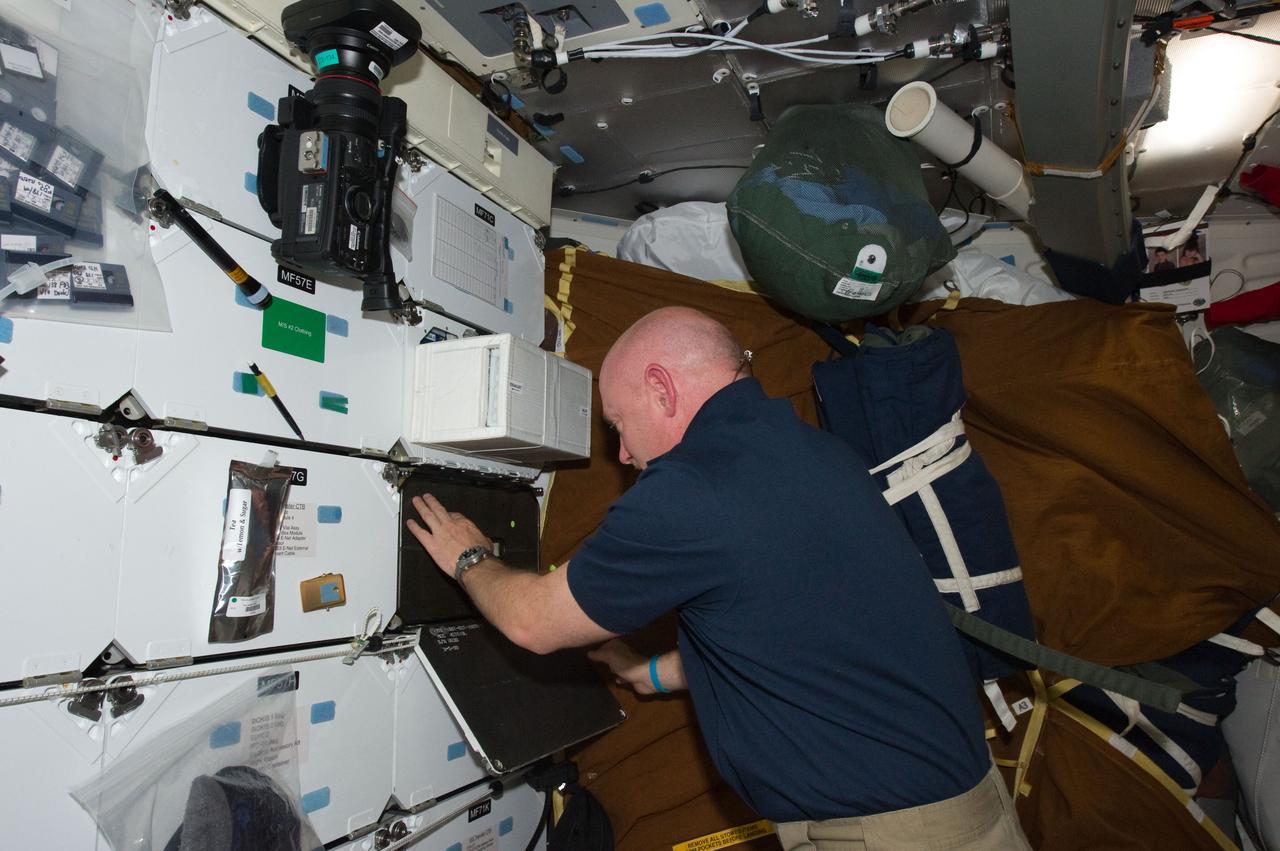 S134-E-007765 (20 May 2011) --- NASA astronaut Mark Kelly, STS-134 commander, works on the middeck of space shuttle Endeavour while docked with the International Space Station. Photo credit: NASA