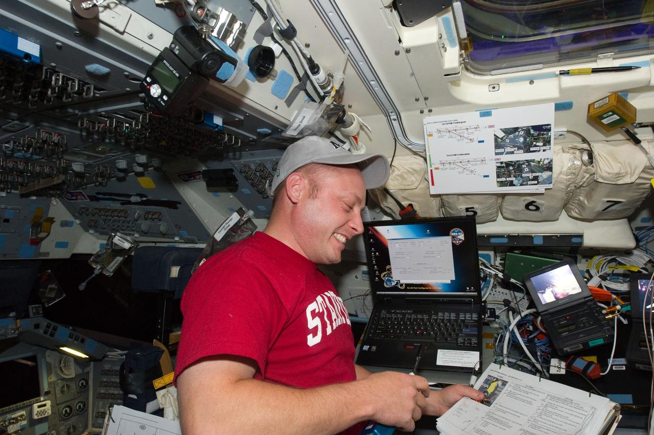 S134-E-007771 (20 May 2011) --- NASA astronaut Michael Fincke, STS-134 mission specialist, works on the aft flight deck of space shuttle Endeavour while docked with the International Space Station. Photo credit: NASA