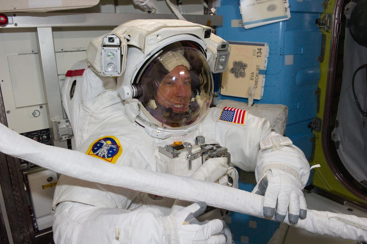 S134-E-008465 (22 May 2011) --- Wearing an Extravehicular Mobility Unit spacesuit, NASA astronauts Andrew Feustel and Michael Fincke (out frame), both STS-134 mission specialists, get prepared for the mission's second spacewalk onboard the International Space Station (ISS). Once outside the orbiting complex,  Feustel and Fincke coordinated their shared activity with NASA astronaut Greg Chamitoff (out of frame), who stayed in communication with the pair and with Mission Control Center in Houston from the shirt sleeve environment inside the ISS. Photo credit: NASA