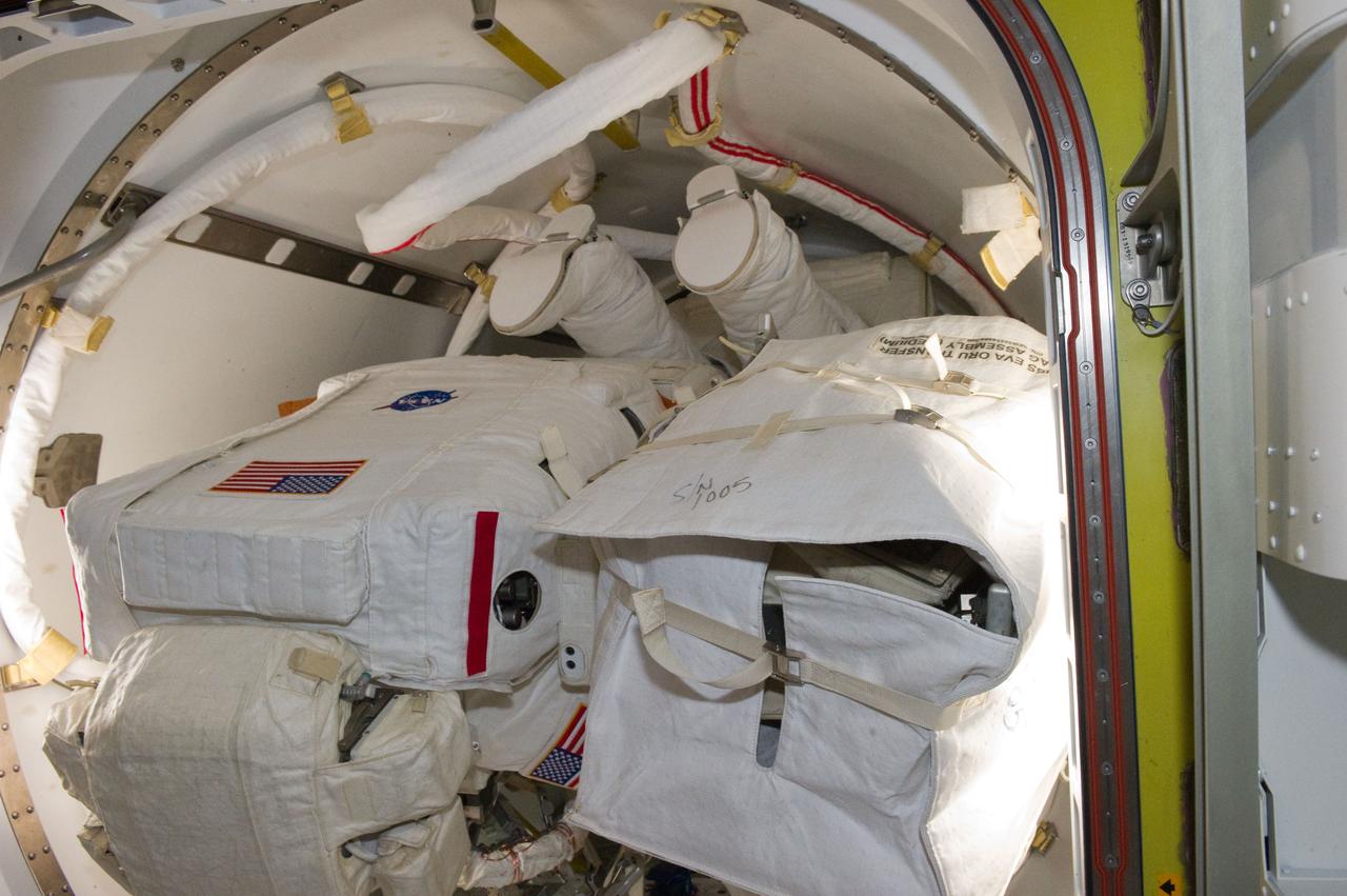 S134-E-008468(22 May 2011) --- The feet and lower legs of NASA astronaut Michael Fincke in the airlock prior to the STS-134 mission’s second space walk, and Fincke’s first for the flight so far. A little later, astronauts Fincke and Andrew Feustel (left side of the frame) both mission specialists, coordinated their shared activity with NASA astronaut Greg Chamitoff (out of frame), who stayed in communication with the pair and with Mission Control Center in Houston from the shirt sleeve environment inside the ISS. Photo credit: NASA