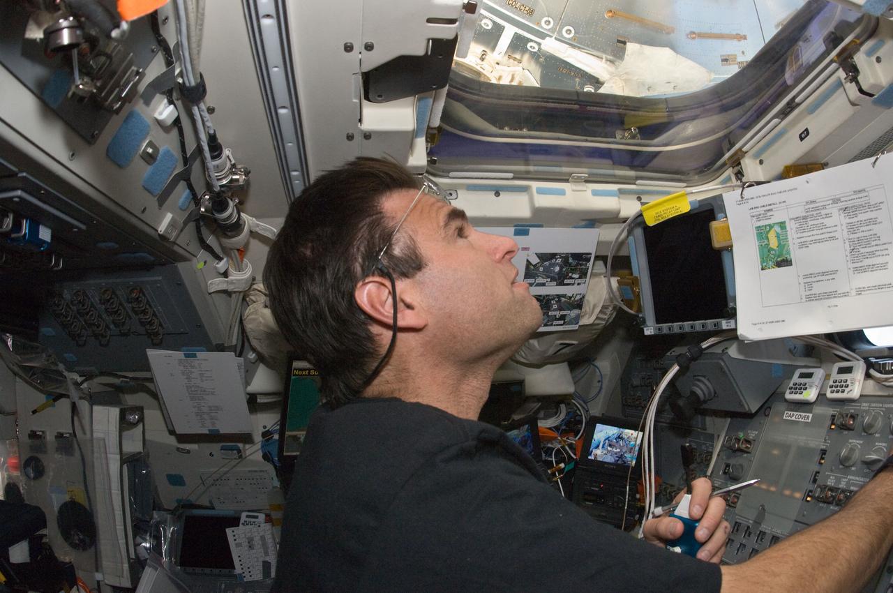 S134-E-009126 (25 May 2011) --- NASA astronaut Greg Chamitoff, STS-134 mission specialist, supports the mission?s third session of extravehicular activity from inside the aft flight deck of space shuttle Endeavour while docked with the International Space Station. Chamitoff choreographed the spacewalkers activities and coordinated communications between the spacewalkers and Mission Control Center in Houston. Photo credit: NASA