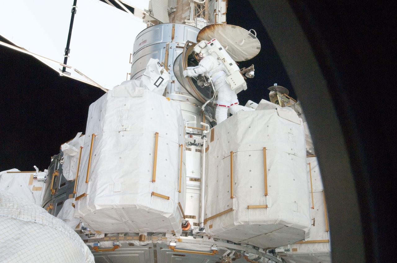 S134-E-009307 (20 May 2011) --- NASA astronaut Greg Chamitoff, STS-134 mission specialist, prepares to enter the Quest airlock of the International Space Station as the mission's first session of extravehicular activity (EVA) draws to a close. During the six-hour, 19-minute spacewalk, Chamitoff and astronaut Andrew Feustel (out of frame) retrieved long-duration materials exposure experiments and installed another, installed a light on one of the station?s rail line handcarts, made preparations for adding ammonia to a cooling loop and installed an antenna for the External Wireless Communication system. Photo credit: NASA