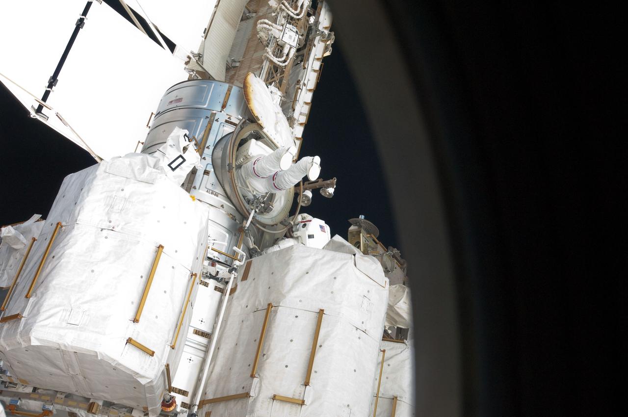 S134-E-009309 (20 May 2011) --- NASA astronaut Greg Chamitoff, STS-134 mission specialist, enters the Quest airlock of the International Space Station as the mission's first session of extravehicular activity (EVA) draws to a close. During the six-hour, 19-minute spacewalk, Chamitoff and astronaut Andrew Feustel (out of frame) retrieved long-duration materials exposure experiments and installed another, installed a light on one of the station?s rail line handcarts, made preparations for adding ammonia to a cooling loop and installed an antenna for the External Wireless Communication system. Photo credit: NASA